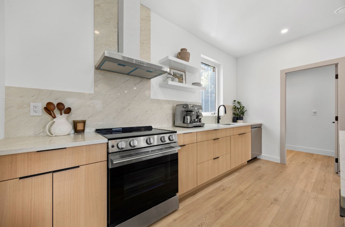 Kitchen with stainless range and quartz counters